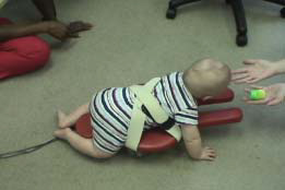 Baby crawling with help from Self Initiated Prone Progressive Crawler